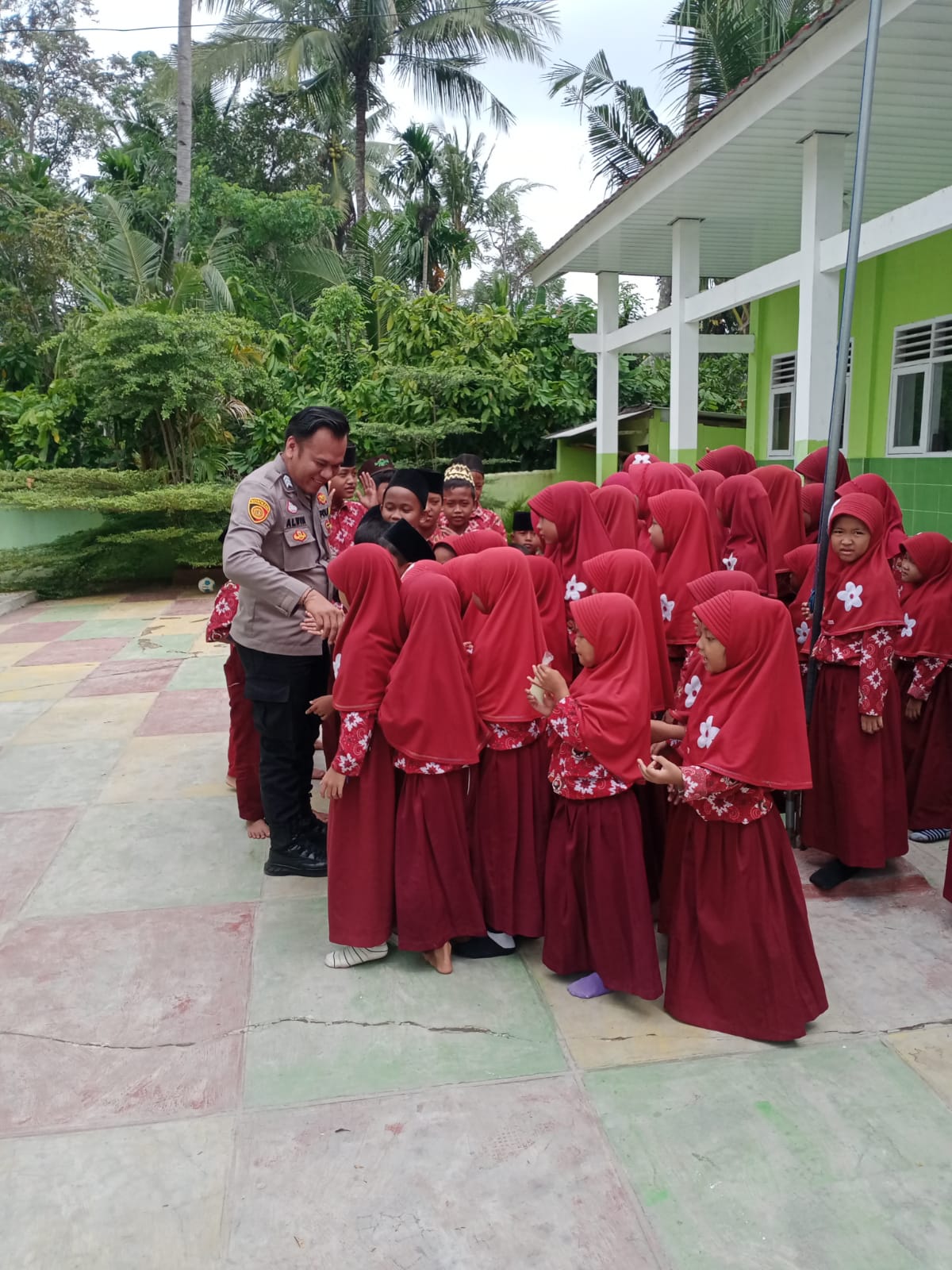 Brigpol M. Alwin Fathoni saat bersama anak anak
